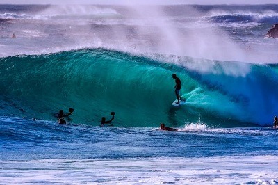 surfeur qui prend un tybe dans une vague